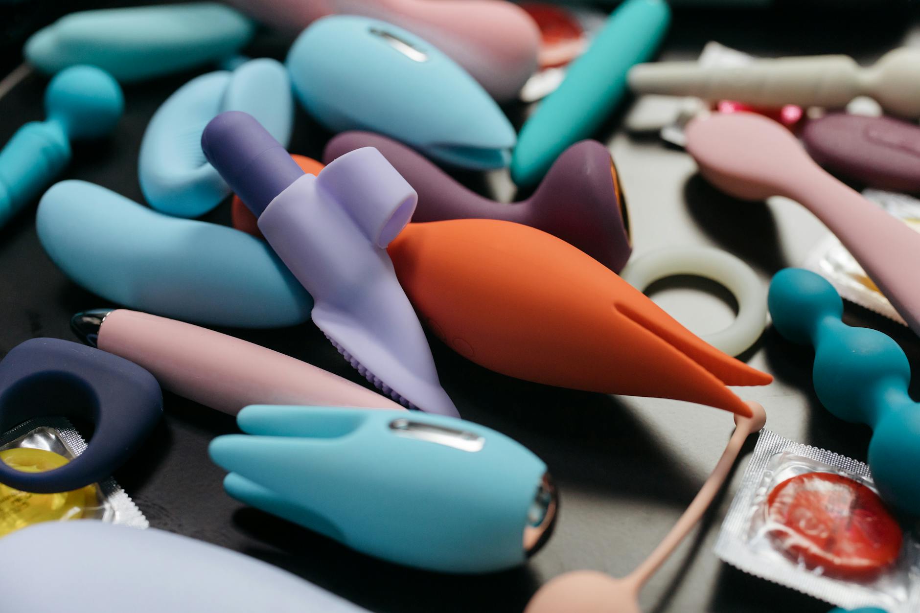 A collection of colorful silicone vibrators and adult toys displayed together