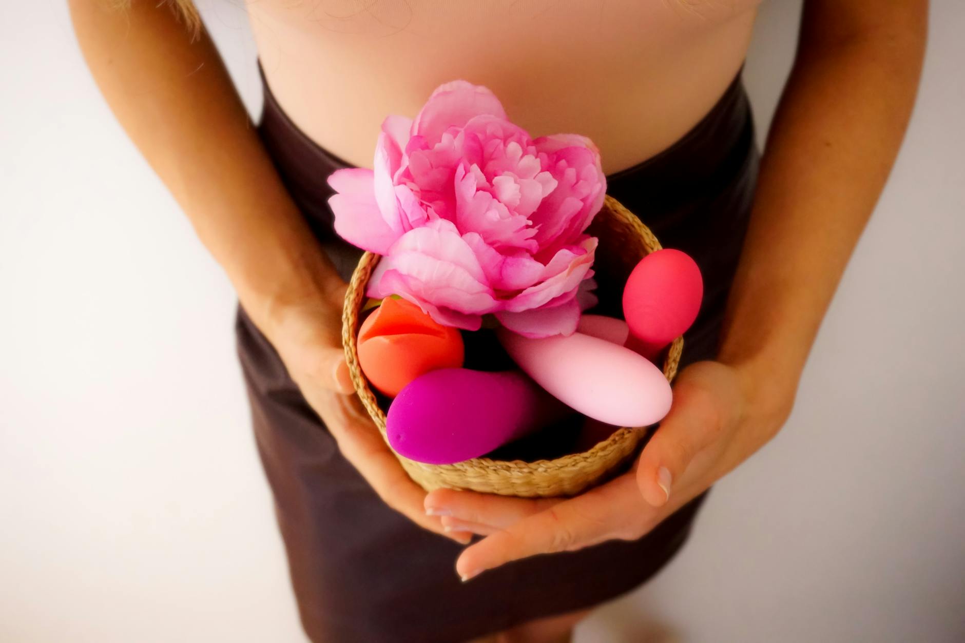 A blue silicone vibrator held gently in hand, representing gentle sensation and body-safe pleasure